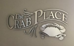 Custom acrylic lobby sign of the Crab Place