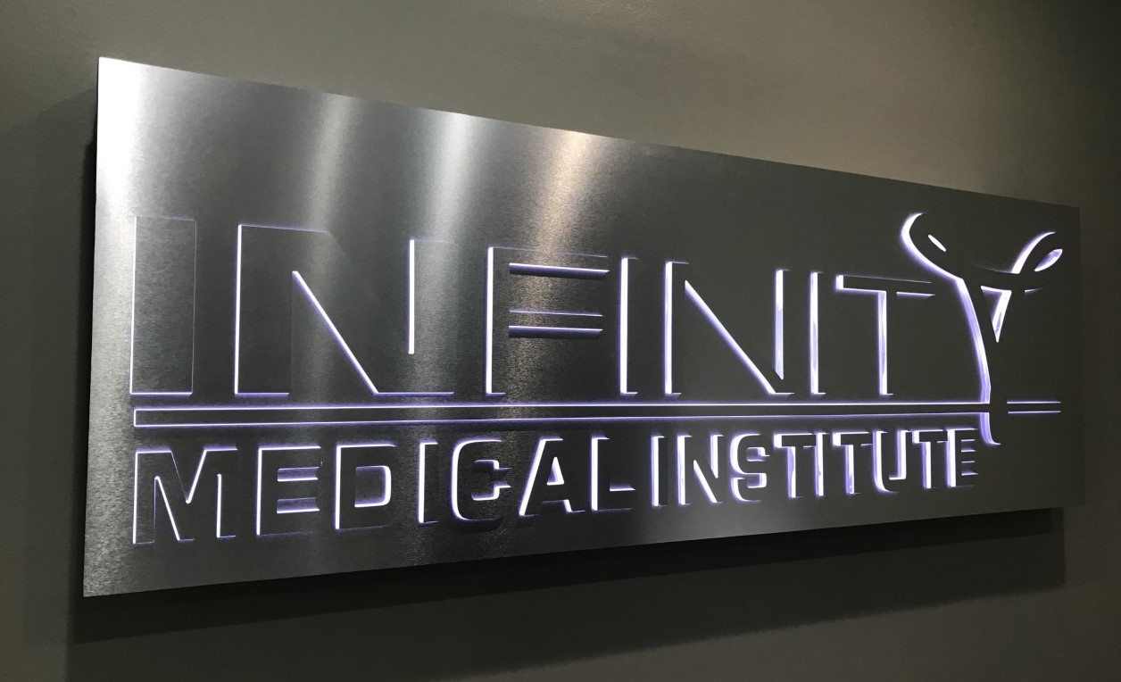 Lighted lobby sign of Infinity Medical Institute in Tampa, FL